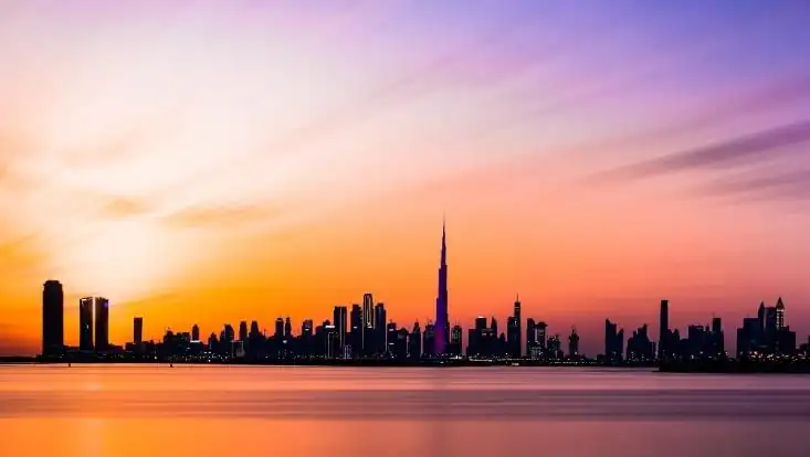 A panorama of Dubai in the sunset sky.