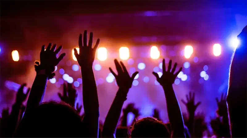 Silhouette of people dancing in a club.